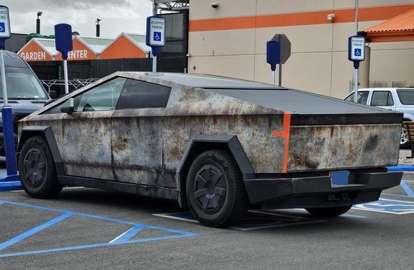 Badly corroded cyberdud with bright orange duct tape holding the back quarter panel on.