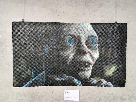 Beaded picture of Gollum from the movie The Lord of the Rings. It's a close up. His eyes are big and blue, he's looking at "his precious".
