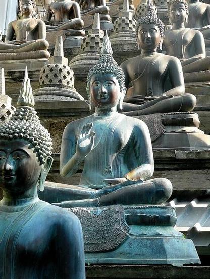 color photo of blue hue stone Buddhas