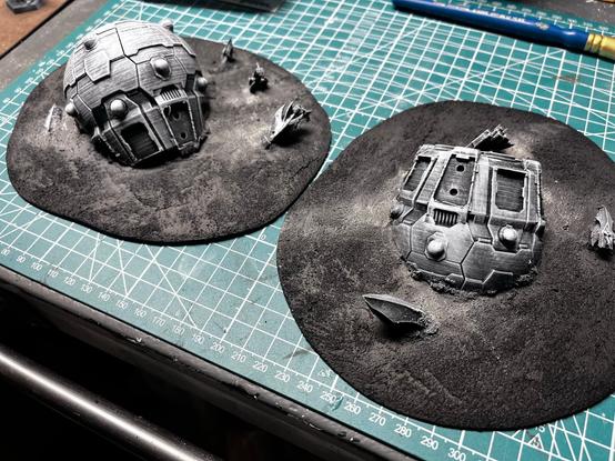 Two terrain pieces, representing large derelict ships surrounded by other, smaller crashed ships.