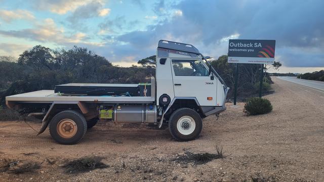 The OKA parked alongside a sign saying Outback SA Welcomes You