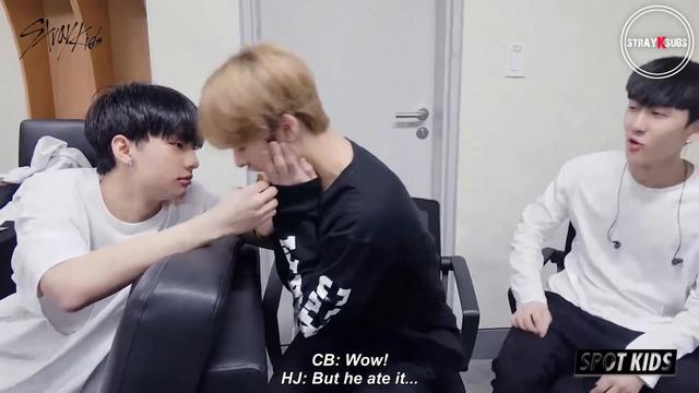 Hyunjin is holding up a gummy sweet. Lee Know is about to eat it out of his hands. Changbin says, "Wow!" Hyunjin says, "But he ate it..."