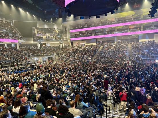 Picture of a multi-level arena packed with Critical Role fans, many of whom are in cosplay.