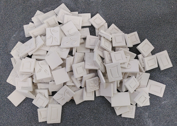 Pile of ceramic mosaic tiles. Leaves, letters, Celtic knots ...