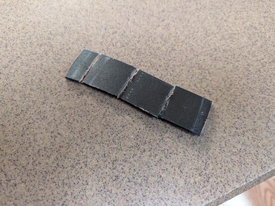 A piece of a leather belt cut into 1 inch segments.