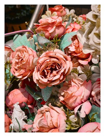 A close-up view of a cluster of pink artificial roses.