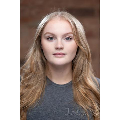 A young woman with long, wavy blonde hair