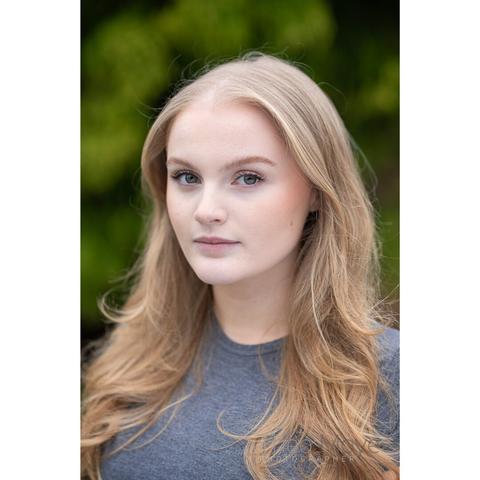 A young woman with long, wavy blonde hair