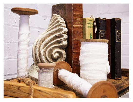 A collection of antique books and old white fabric.