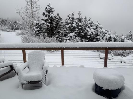 Deck chairs and solo stove on the front deck draped with new snow overnight.