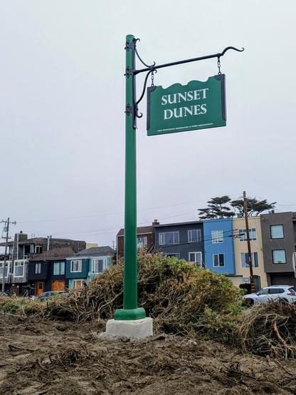 A green SF Parks and Recreation sign with the text "Sunset Dunes"