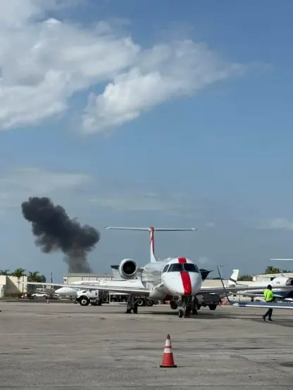 plume of smoke in sky in backdrop of BCT airport