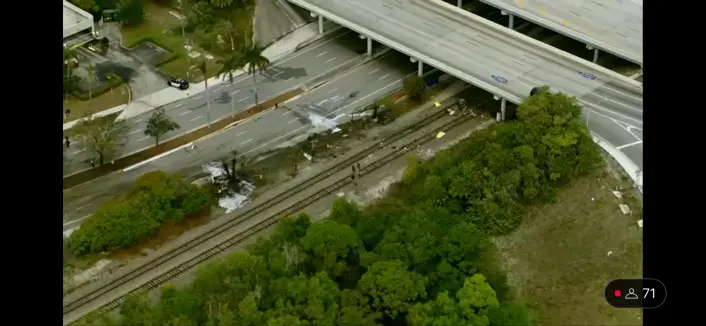aerial view of crash site. near railroad and bridge.