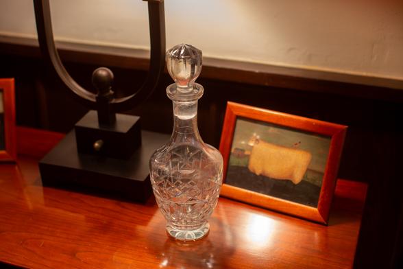 Crystal decanter with a large glass stopper.