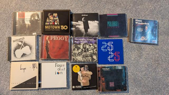 A photo of CDs on a floor with these being by :
This is Electronic Body Music, Motown 50, Goldfrapp, Malaria!, Klaus Wunderlich
Silver Apples, Peggy Lee, The Langley School Music Project, Factory Floor
Fader, Carl Taylor, Andreas Dorau, Gavin Bryars