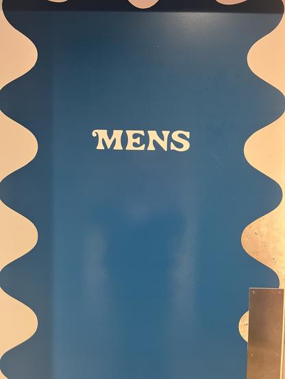 It’s a series of three doors. This one is the men’s bathroom and it is labeled mens with no apostrophe.