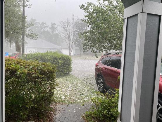 Hail falling into yard during hailstorm