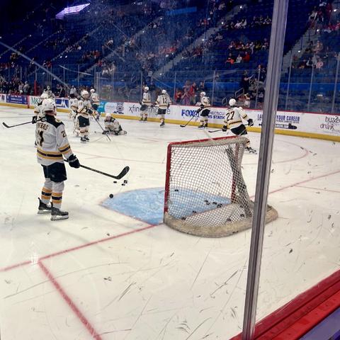 Ice-level shot of the Providence Bruins warming up.