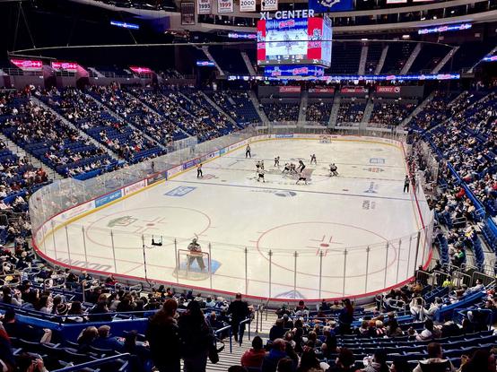 Wide shot of the whole rink at the puck drop to open the game.