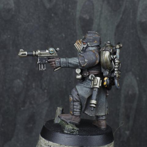 Left side view of the same miniature, showing their auto pistol. A hand grenade is attached to their belt.