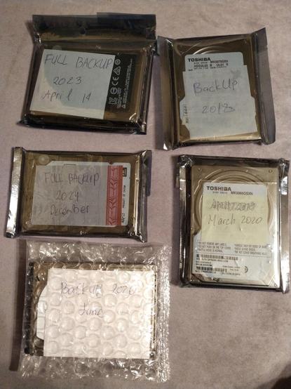 Couple of 2.5" HDDs with different labels "backup" on them