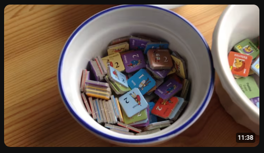 A cup of brightly colored cardboard chits for a board game.