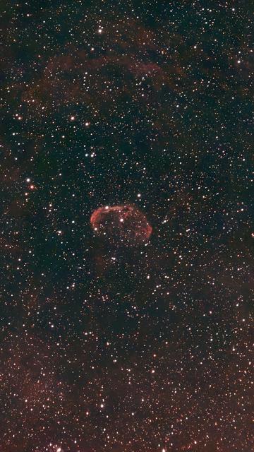 Crescent Nebula in the constellation Cygnus. Small reddish nebula surrounded by stars. Not the best photo as the moon was shiny and lots of light pollution facing east.