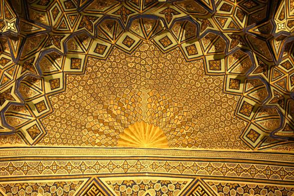 An ornate golden ceiling with intricate patterns in Samarkands Gur Emir mausoleum