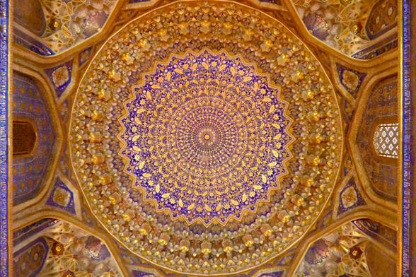 An ornately decorated, golden dome with rich patterns