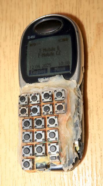 A Siemens S45i cellphone ("dumbphone") where the keypad has been replaced by through-the-hole mounted mini push buttonssoldered on a breadboard PCB. Replacement keyboard PCB fixed on top to the device using transparent silicone and epoxy two component glue.