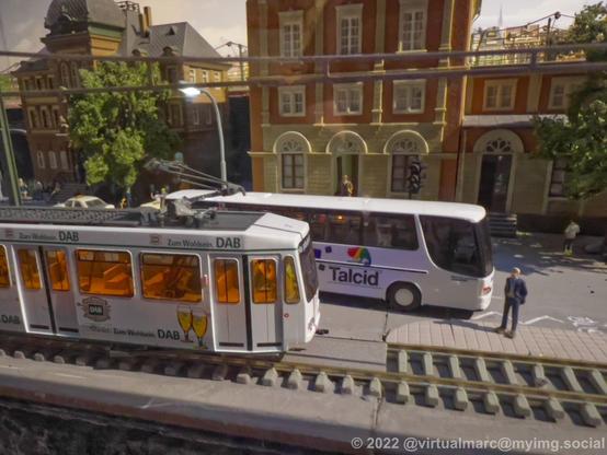 A close up detail photo of a tram and a bus in a city.