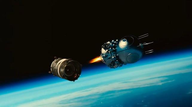 A spaceship floating in orbit above Earth separates from its booster rocket