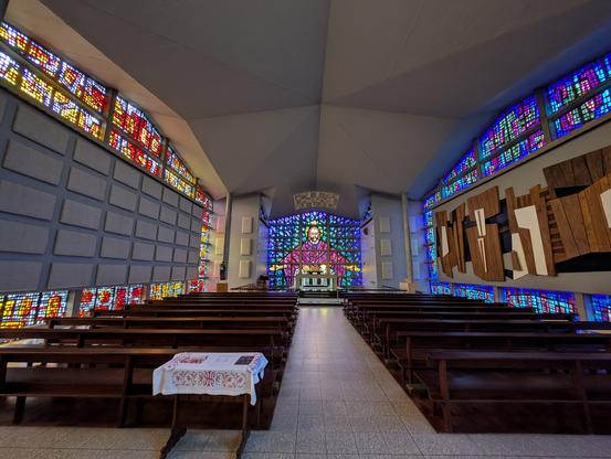 A trippy, colourful churching space. A glowing psychedelic figure spreads his arms in a pixelated display down the far end, as if offering appropriate mushrooms.