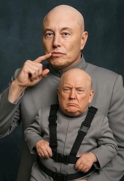 A humorous image depicting two individuals dressed in matching grey outfits, styled to resemble characters from the movie "Austin Powers." The larger individual, standing behind, is holding a finger to their lips in a "shushing" gesture, while the smaller individual, strapped to the larger one's chest with a harness, has a displeased expression. The background is a plain dark teal color.