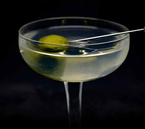 The cocktail itself in a chilled coupe and garnish with an olive