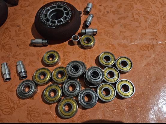a whole lot of bearings, like 16+. Some bearing spacers, and an inline skate wheel. the bearings with gold looking sides are class abec 7. the iron gray looking ones are abec 5.