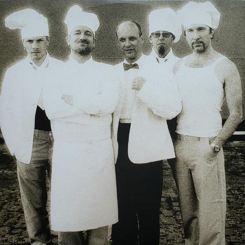 One of the inner sleeves of the Record Store Day 2025 release of Passengers - Original Soundtracks 1. The photo shows four men dressed as restaurant chefs and one man in the center dressed as a Maître d.
