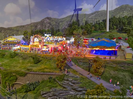 A photo of a fair/carnival on a model railway.
