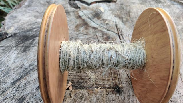 A spindle of cream coloured yucca thread. The diameter is not even, and the tension is all over the place, but I'm still very proud of my first attempt.