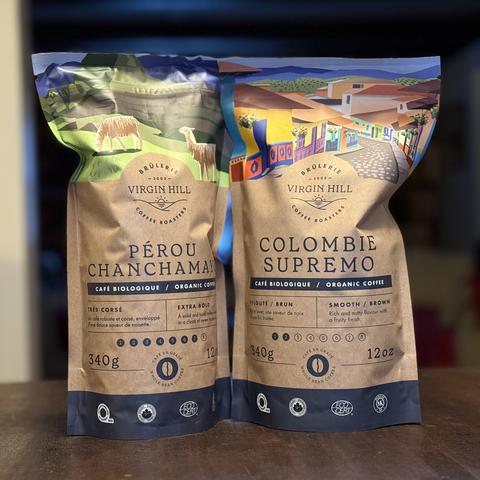 Two bags of virgin hill coffee beans. Left bag is an extra bold Peru blend and right bag is a smooth Colombian brown.