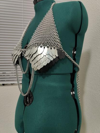 A low side view of the chainmail piece described in the post. It is modeled on a mannequin with a plain background.