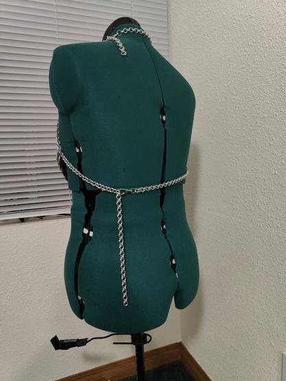 A back view of the chainmail piece described in the post. It is modeled on a mannequin with a plain background.