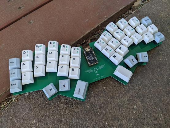photo of a barebones monoblock split ergo-mechanical keyboard - currently it is just a single PCB, through-hole diodes, Wuque Arowana switches, Yuzu custom keycaps, and an Elite-C microcontroller