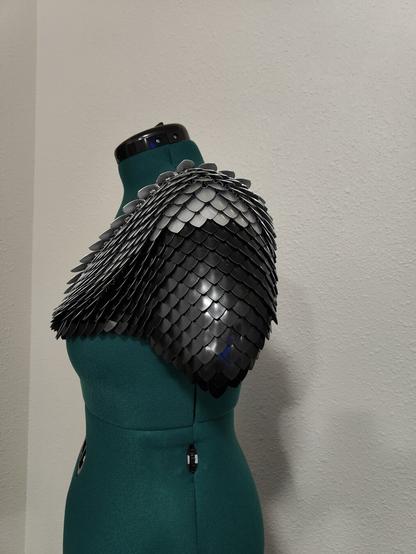 A side view of the piece described in the post. It is modeled on a mannequin with a plain background.