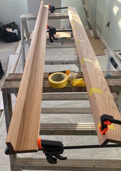 Two sets of two long hardwood boards glued together at right angles.