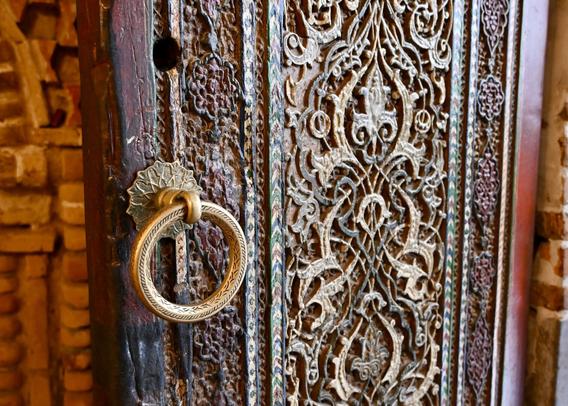 Detail of an old wooden door with intricate woodwork