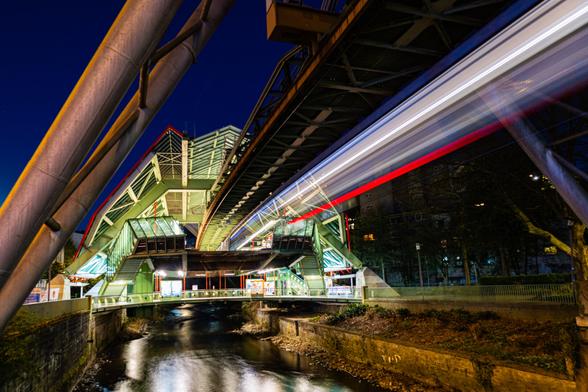 Long exposure of a monorail train entering a station.