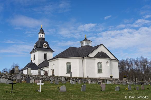 A white church with a cemetery.
