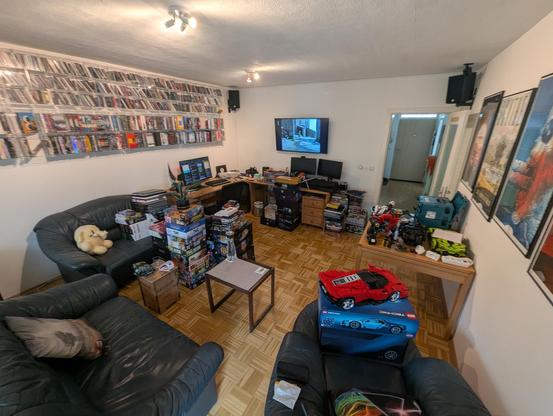 Living room, taken from one corner. There's stacks of boardgames everywhere