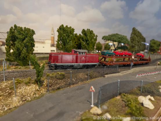 A photo of a car transporting train on a model railway.